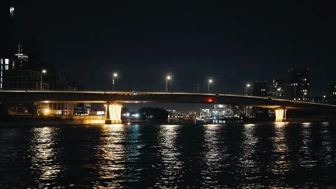 A large bridge over a river in the city at night Stock Footage 318384657
