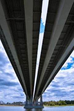 Large bridge over the river, view from below. On the background of contrastin Stock Photos