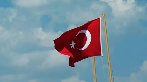 A large bright flag of Turkey flutters on a flagpole Stock Footage 244397201