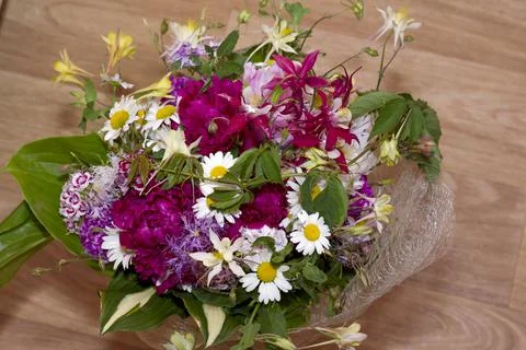 Large bright multi-colored bouquet of wildflowers with peonies and aquilegia Stock Photos