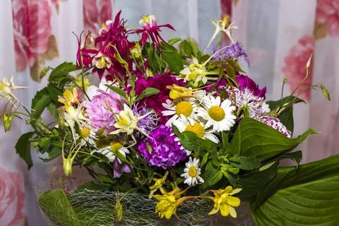 Large bright multi-colored bouquet of wildflowers with peonies and aquilegia Stock Photos