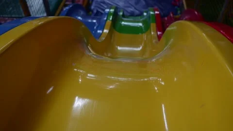 A large bright multi-colored slide in a shopping and entertainment center Stock-Footage 220734528