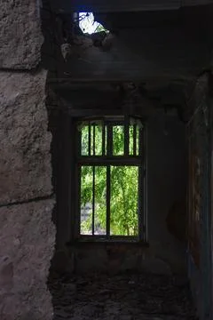 A large broken window in an old destroyed building. Old ruined haunted house, Stock Photos