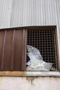 Large broken window in an old destroyed building. Old ruined haunted house, a Stock Photos