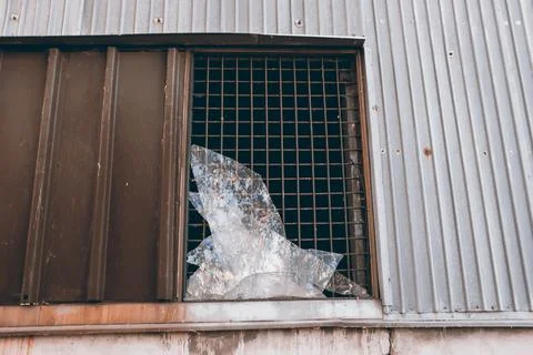 Large broken window in an old destroyed building. Old ruined haunted house, a Stock Photos