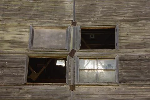 Large broken window in an old destroyed building. Old ruined haunted house, a Stock Photos