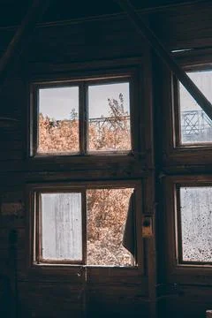 Large broken window in an old destroyed building. Old ruined haunted house, a Stock Photos