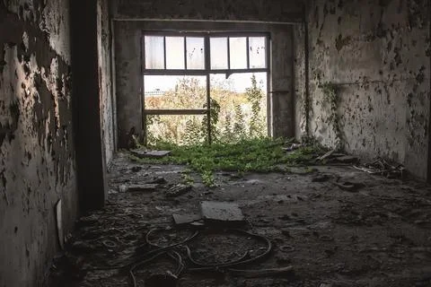 A large broken window in an old destroyed building. Old ruined haunted house, Stock Photos