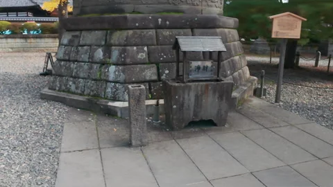 Large bronze buddha statue sitting on a stone pedestal in a Japanese Temple Video stock 332133005