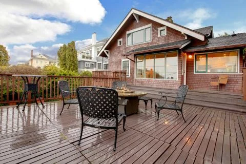 Large brown house with back deck exterior rain winter shot Stock Photos