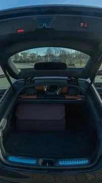 Large brown organizer box inside a clean modern car trunk. Open trunk of a .. Stock-Fotos