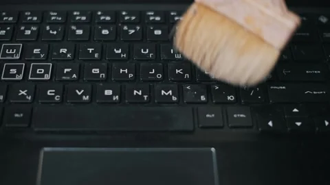 Large Brush Sweeping Dust Off Notebook Keyboard Stock Footage 319482134