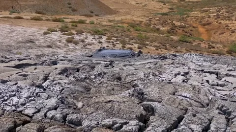Large bubbles are inflating in a mud volcano Stock-Footage 316880967