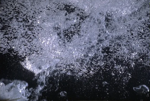 Large bubbles rising into a layer of tiny bubbles, viewed from below the surface Stock Footage 86919402