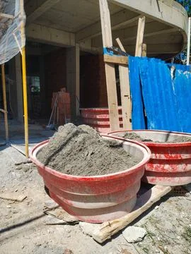 Large buckets of cement at the construction site. Stock Photos
