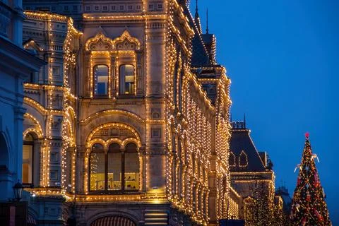 A large building with a christmas tree in front of it Stock Photos