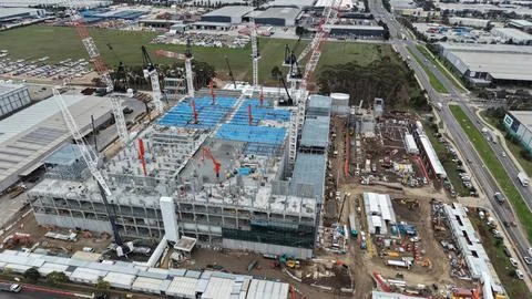 Large building construction site with multiple cranes working Stock Photos