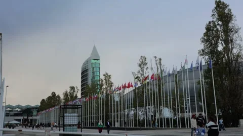 A large building with country flags on the side. Parque das Nacoes, Lisbon, Stock Footage 303995089