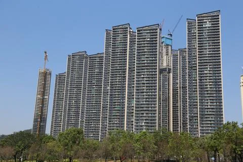 A large building with a crane in the background Stock Photos