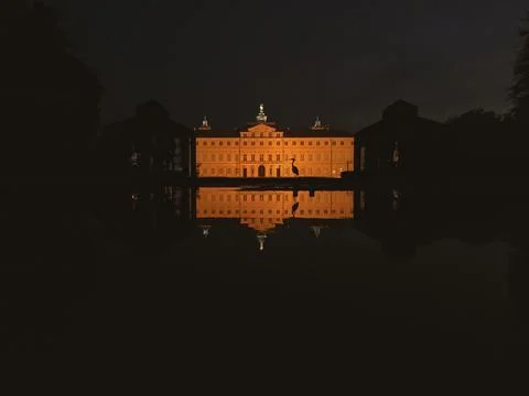 A large building with a large window is reflected in the water Stock Photos
