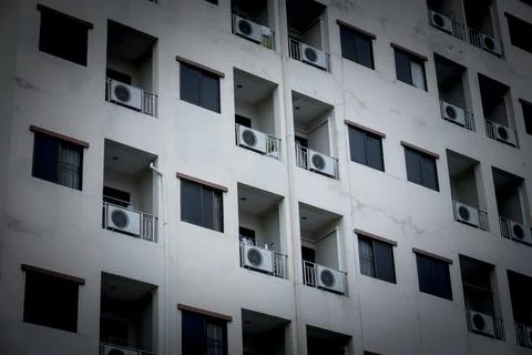 A large building with many windows and air conditioners Stock Photos