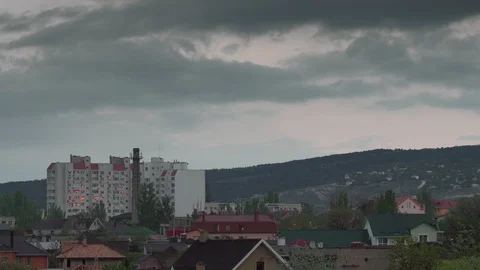 A large building on the outskirts, the windows reflect the red sun at sunset Stock Footage 129832127