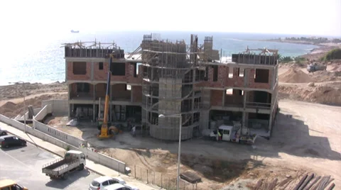 Large building under construction with scaffolding on the coast Stock Footage 39858935