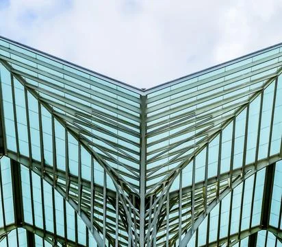 A large building with a unique design, featuring a triangular roof Stock Photos