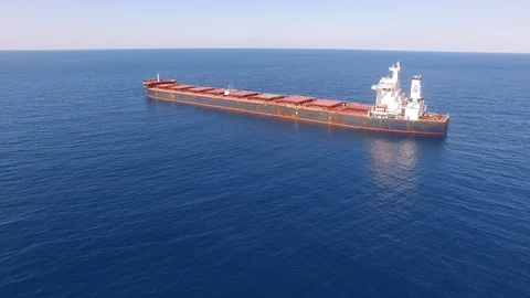 Large bulk carrier ship sailing in open oceanl  - aerial 4k view Stock Footage 110810991