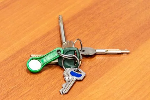 Large bunch of different keys with an electronic key lies on a wooden surface Stock Photos