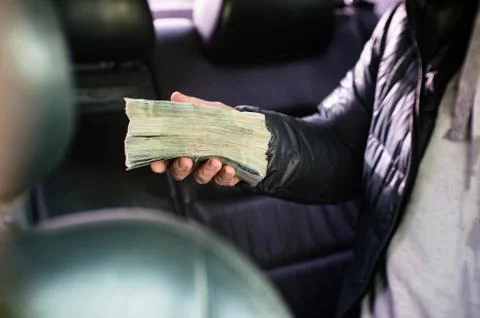 A large bundle of Russian money is squeezed in his hand. Stock Photos