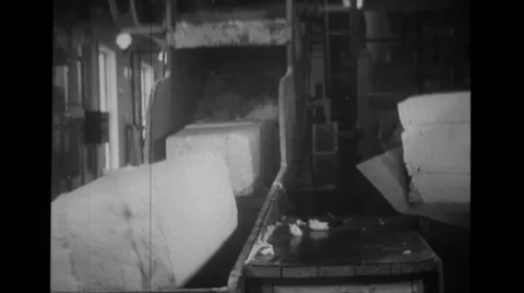 Large bundles of raw material being put into machine Stock Footage