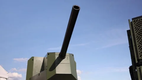 Large caliber artillery cannon mounted on modern armored military platform Stock Footage 346451364