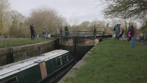A large canal boat going through a lock at Beeleigh, Essex, UK. 4K tripod Stock Footage 170698818