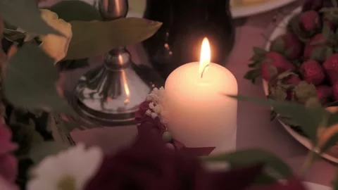 А large candle is lit on a festive table Stock Footage 139439375