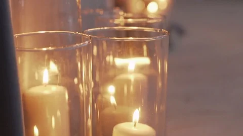Large candles burn in glass flasks Stock Footage 106945030