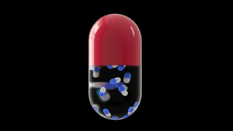 Large capsule on a black background with small pills inside Stock Footage 125976076
