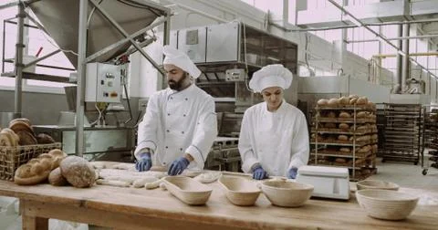 Large capturing video in a big bakery industry industrial machine bakers working Stock Photos