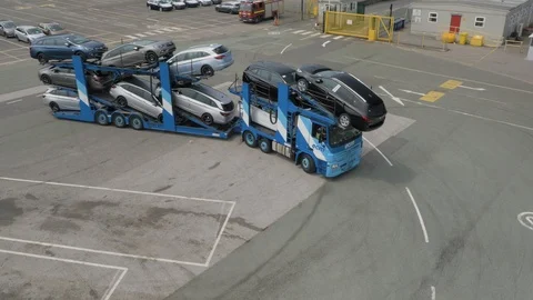 Large car transporter making a turn in industrial estate , drone aerial 4K Stock Footage 101122047
