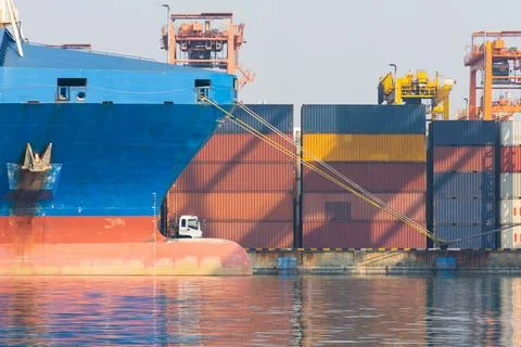 The large cargo container ship moor by rope at terminal container yard port. Stock Photos