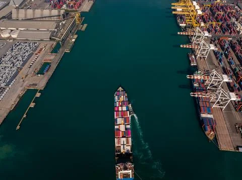 Large Cargo Container Ship Navigating Through Industrial Port Channel High .. Stock Photos