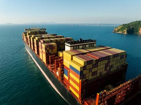 Large Cargo Container Ship Sailing Past Tropical Coastline Near Chon Buri T.. Stock Photos