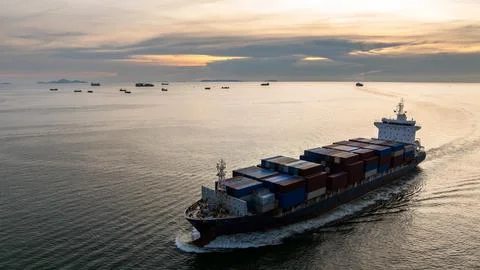 Large Cargo Container Ship Sailing Across Ocean At Sunset In Si Racha Thail.. Stock Photos