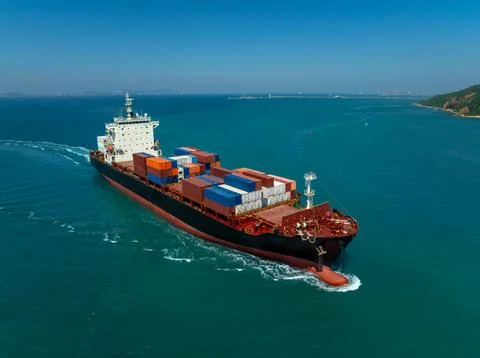 Large Cargo Container Ship Transporting Freight Across Turquoise Ocean Wate.. Stock Photos