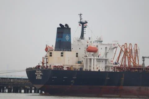 Large cargo export ship standing on a dockyard. Stock Photos