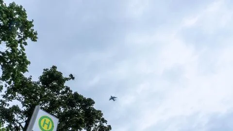 A large cargo plane flies low in the sky Stock Photos