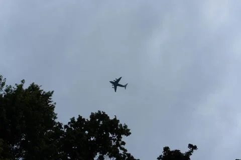 A large cargo plane flies low in the sky Stock Photos