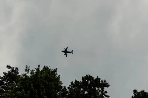 A large cargo plane flies low in the sky Stock Photos