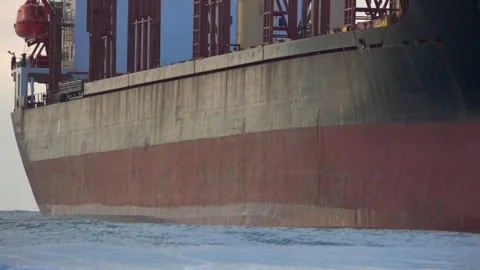 A large cargo sea ship sails on the ocean among the waves Video stock 257101125