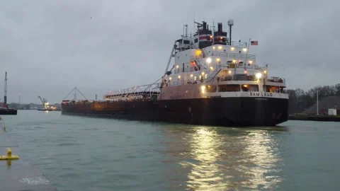Large cargo ship is baking our of the harbor early in the morning Stock Footage 212236194